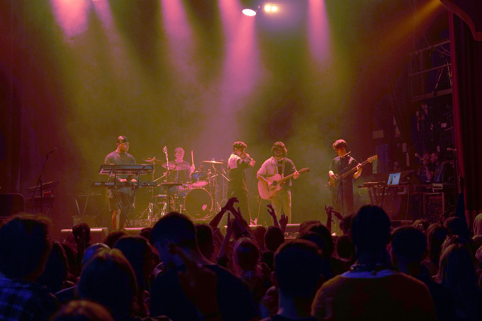 Stephen Mathes and his band mid-set under magenta and amber stage light