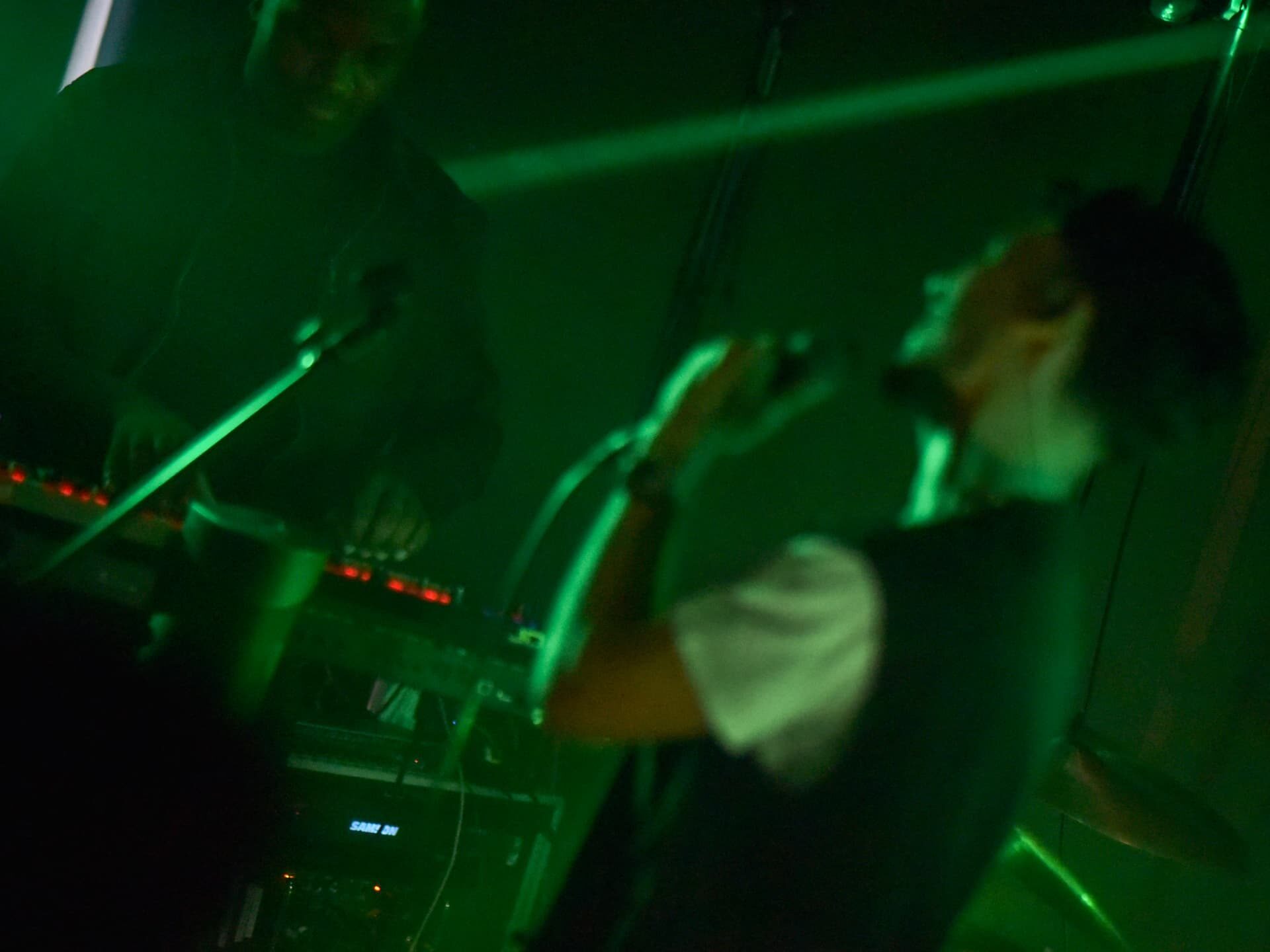 Stephen Mathes performing in green stage light